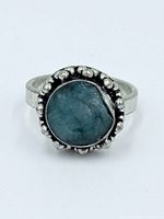 Top view of sterling ring showing emerald cabochon and beaded bezel