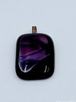 Front view of rectangular purple fluorite pendant