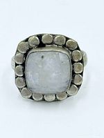 Front view of moonstone sterling silver ring showing gemstone and dotted border