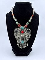 Full necklace on display bust showing pendant and beaded strand