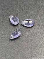 Three tanzanite gemstones on black background