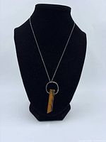 Full necklace on display bust showing chain length and pendant