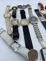 Group view of left section showing eight assorted wristwatches