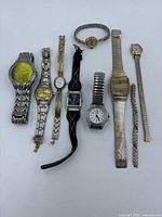 Group shot of all eight watches and loose strap