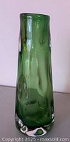 Front view of meadow green knobbly art glass vase with clear base