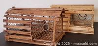 Two small wooden lobster traps side by side angled view