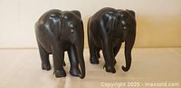 Front view of both ebony elephant figurines