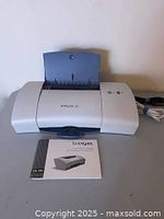 Front view of Lexmark Z25 printer with manual and cables visible