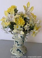 Vase with faux flowers displayed