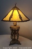 Lamp lit showing full view, shade glow and glass finial