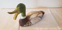 Left profile of carved wooden mallard decoy