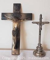 Both crucifixes standing side by side to show size comparison and overall appearance