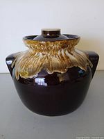 Front view of stoneware bean pot with lid showing drip glaze