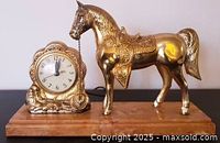 Front view showing horse figure and clock on marbled base