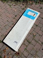 Sealed rectangular box lying on brick surface