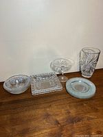 Group shot of all six crystal and glass pieces on wooden surface