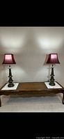 Both brass lamps on table, full view