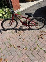 Full left-side view of red SuperCycle SC1800 bike on brick driveway