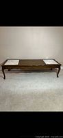 Full view of wooden coffee table with marble inserts