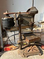 Full side view of drill press showing motor, column, table and base