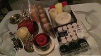 overview of assorted candles, holders, snuffer on table