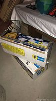 Two Bilstein branded boxes stacked on concrete floor