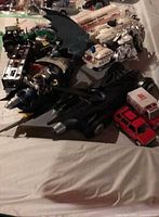 Mixed Batman and emergency toy vehicles spread on table