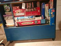 Shelf with stacked board games and magic set