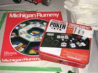 Closed Michigan Rummy box beside WSOP Texas Hold’em tin