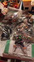 Multiple sealed bags containing loose action figures and parts