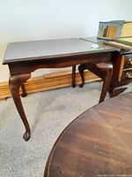 Side view of wood end table showing cabriole legs and overall form