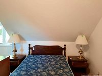 Pair of lamps on bedside tables showing full height, shades, bases