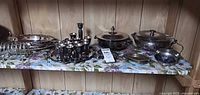 Full shelf view showing all silver-plated pieces together