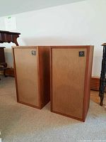 Front view of both Rectilinear XI-A speakers showing grilles and badges