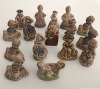 Group of nursery-rhyme character figurines displayed on white surface
