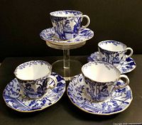 Four cups and saucers grouped to show pattern and quantity