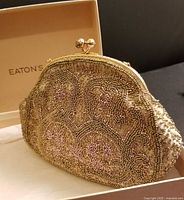 Gold beaded purse inside Eaton's box angled view