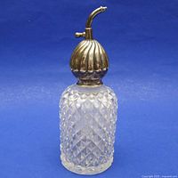 Front view of cut crystal atomizer with sterling silver top