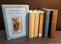 All six hardbound books standing side by side