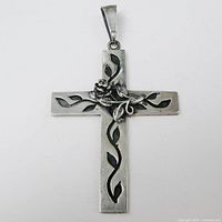 Front view of sterling cross pendant showing rose and vine