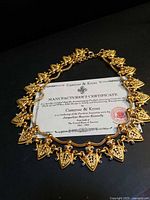 Necklace laid around manufacturer’s certificate