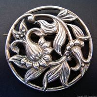 Front view of Danecraft sterling floral brooch showing openwork design and floral motifs