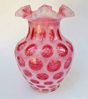 Full front view of opalescent cranberry coin dot vase showing pattern and rim