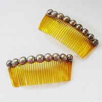 Top view of both combs showing amber hue and silver bead row