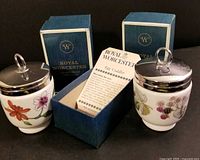 Both egg coddlers with boxes and leaflet visible