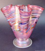 Full view of iridescent pink Arte Vargas vase showing ruffled rim and multicoloured swirls