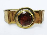 Front view showing brass bracelet and glass cabochon