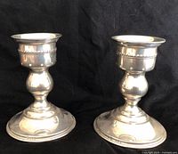 Front view of both sterling candlesticks
