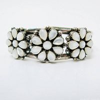 front view of sterling cuff showing three mother of pearl daisy clusters