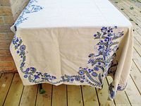 Tablecloth draped over table showing border design